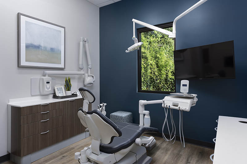 A dental hygienist with a patient at Roane Family Dental.