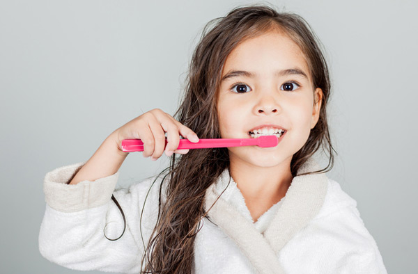 Young girl brushing her teeth at Roane Family Dental in West Linn, OR