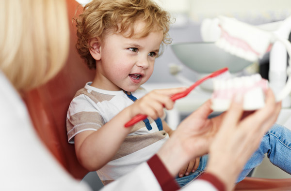 Little boy learning to brush teeth at Roane Family Dental in West Linn, OR